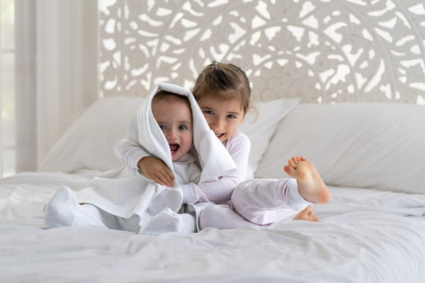 Siblings with Arubana hooded towel